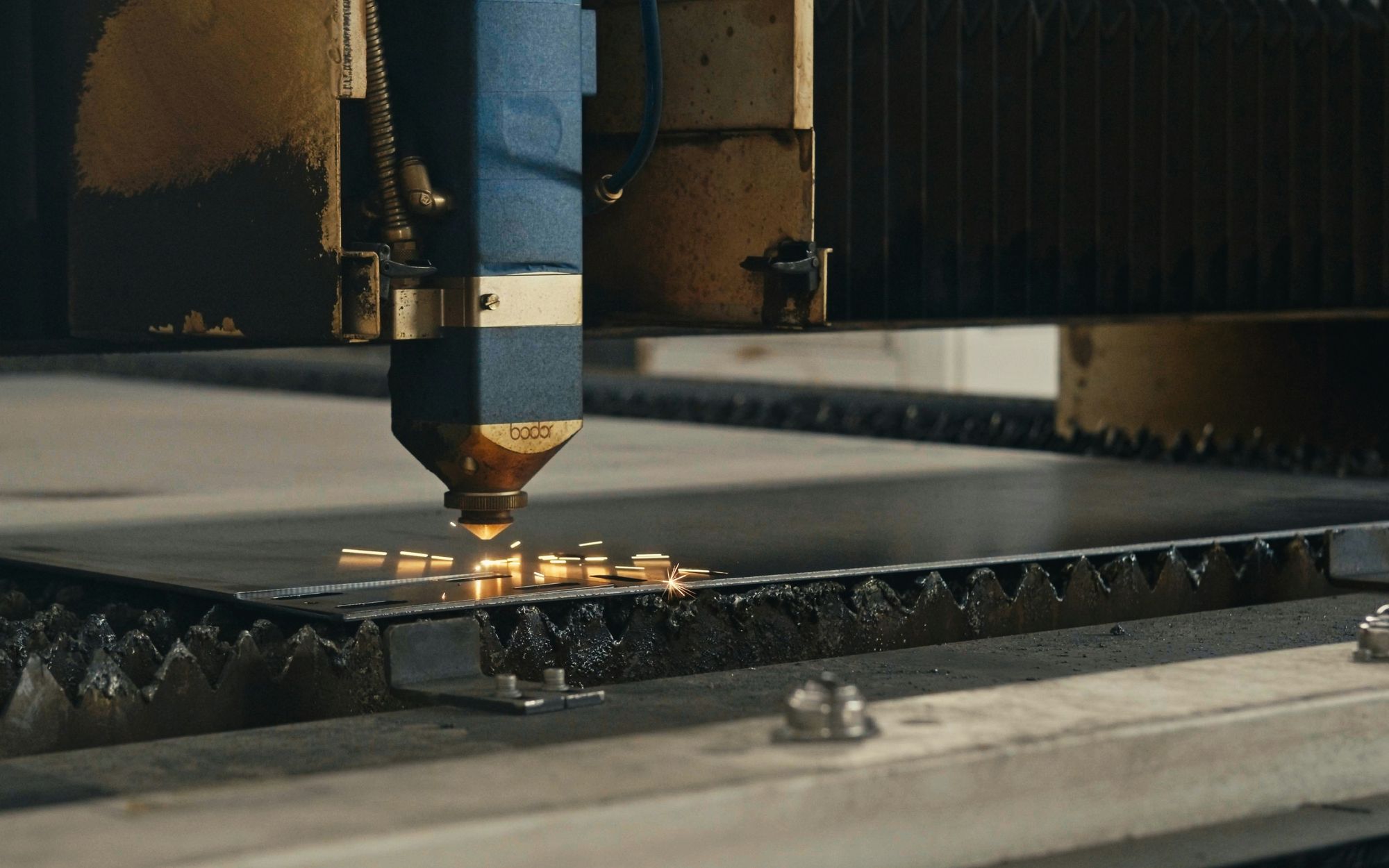 Laser cutting machine processing a metal sheet